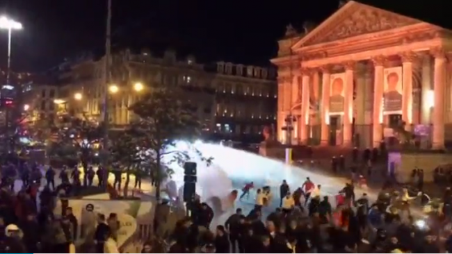 Police fire a water cannon at rioting youths in Brussels, Belgium, Nov. 11, 2017.