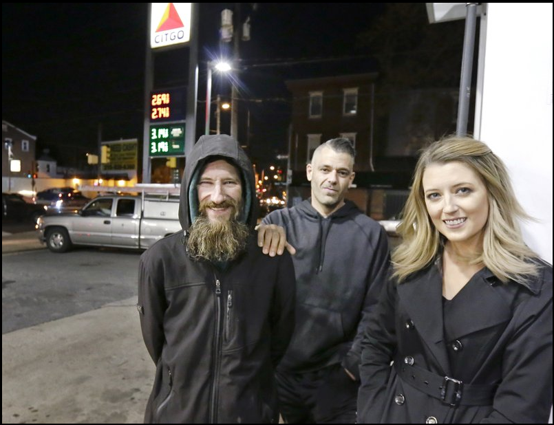 In this Nov. 17, 2017 photo, Johnny Bobbitt Jr., left, Kate McClure, right, and McClure’s boyfriend Mark D’Amico pose at a CITGO station in Philadelphia. When McClure ran out of gas, Bobbitt, who is homeless, gave his last $20 to buy gas for her. McClure started a Gofundme.com campaign for Bobbitt that has raised more than $13,000.