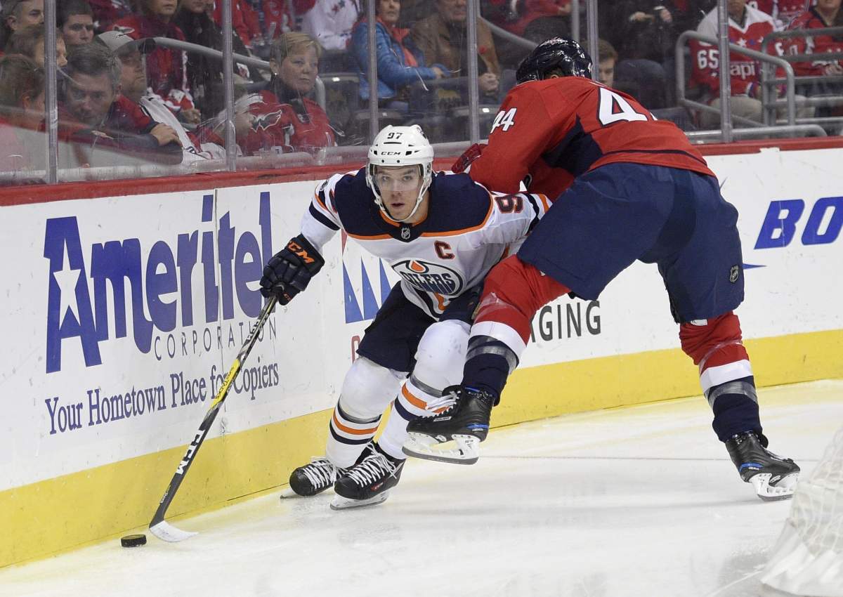 Edmonton Oilers center Connor McDavid (97) skates with the puck against Washington Capitals defenseman Brooks Orpik (44) during the first period of an NHL hockey game, Sunday, Nov. 12, 2017, in Washington.