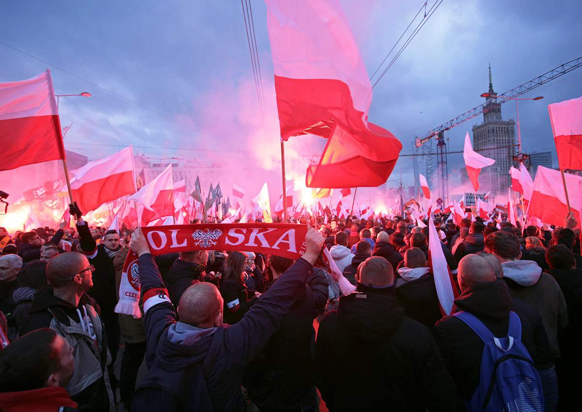 Protesters carry Polish flags and National Radical Camp flags during a rally, organised by far-right, nationalist groups, to mark 99th anniversary of Polish independence in Warsaw, Poland November 11, 2017.