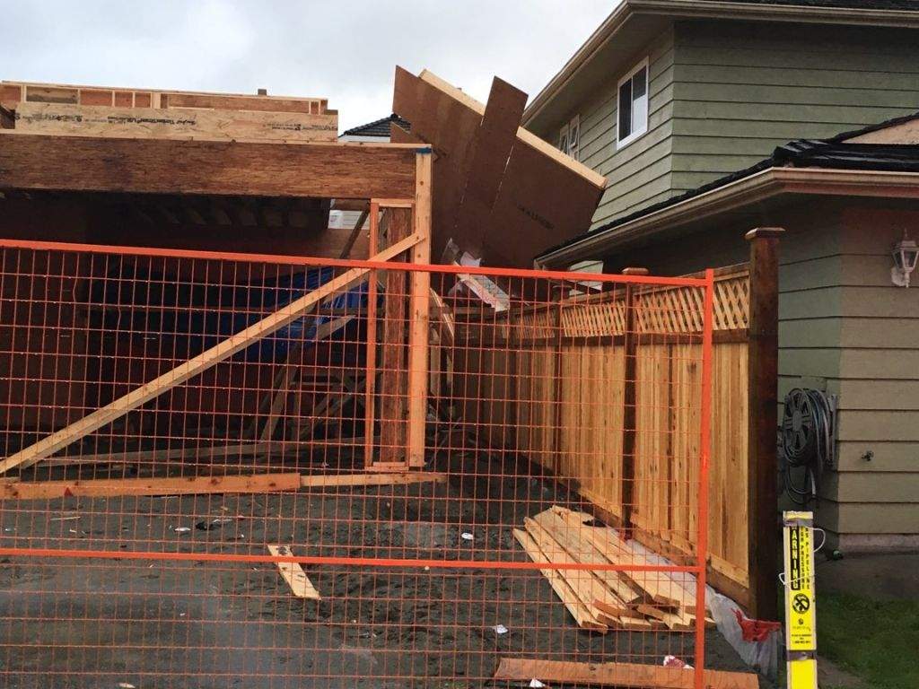 The upper side wall of a home that fell on to an adjacent one amid high winds on Nov. 13, 2017.
