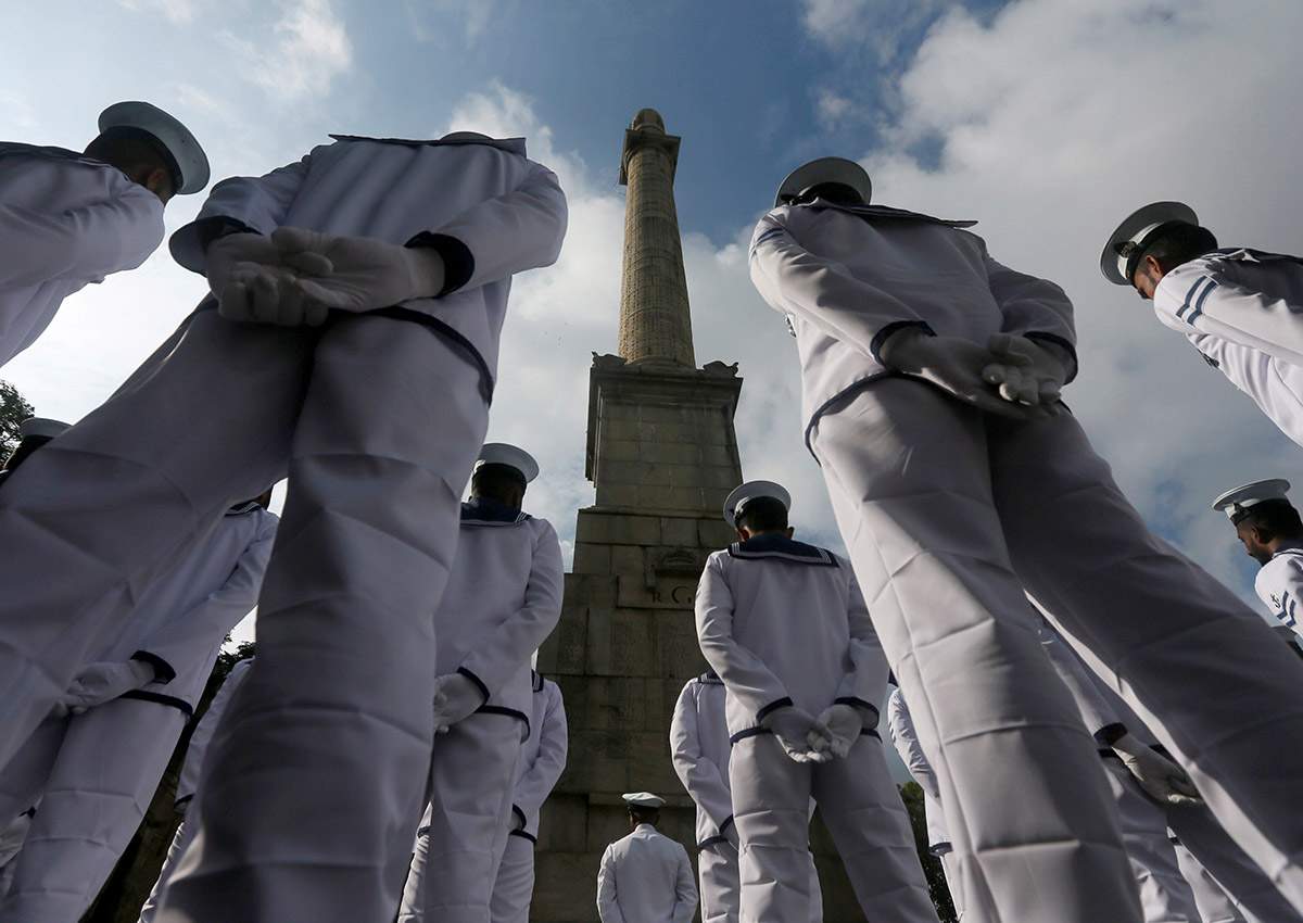 Sri Lankan Navy soldiers stand in front of the War Memorial, during an event marking Remembrance Day, also known as Poppy Day, to commemorate the sacrifices of members of the armed forces and of civilians in times of war, in Colombo, Sri Lanka, on Nov. 11, 2017.