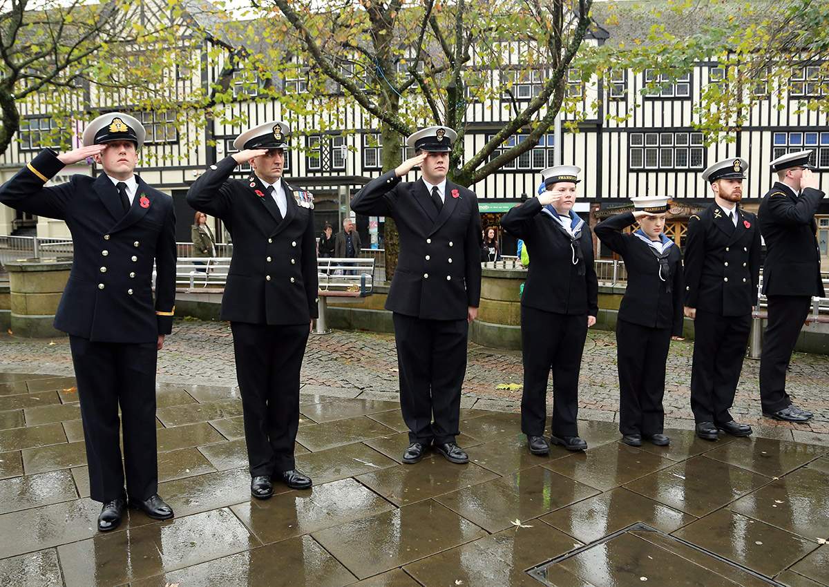 Young people in uniform salute before the two minute silence during Armistice Day Commemorations in Swansea, Wales. Dimitris Legakis/REX/Shutterstock