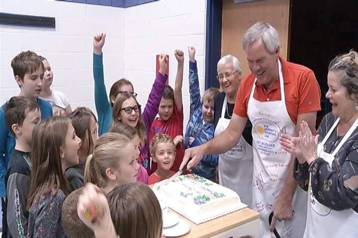 Breakfast program founder Jim Barry celebrates as the children he serves cheer him on.