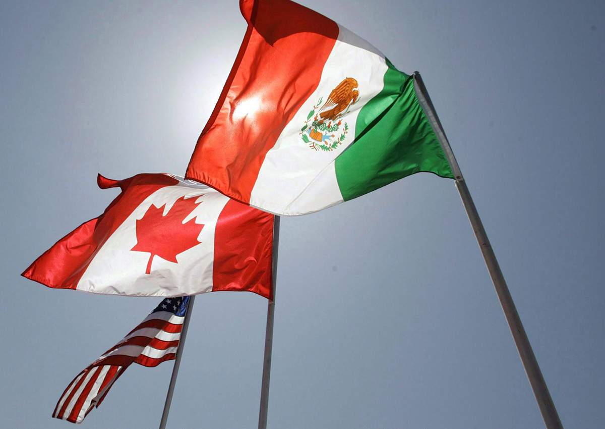 In this April 21, 2008 file photo, national flags of the United States, Canada, and Mexico fly in the breeze in New Orleans.
