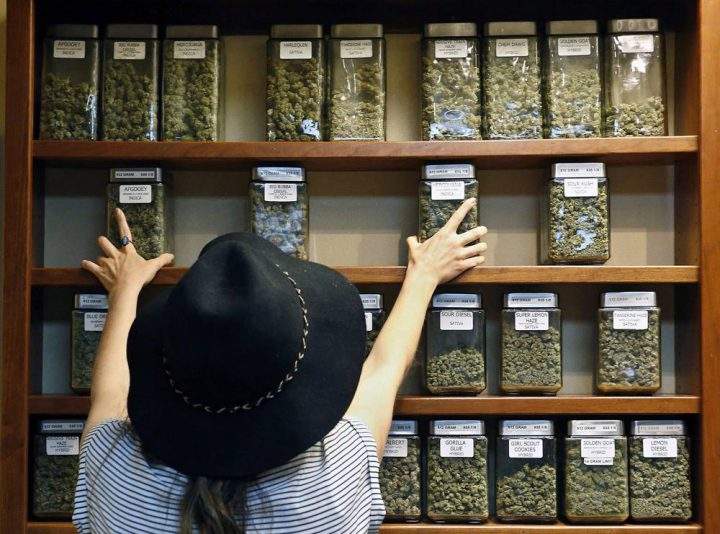 A store worker arranges jars of marijuana at a store in Boulder, Colo. in this file image. 
