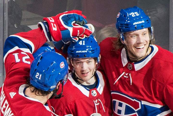 Montreal Canadiens' Paul Byron, centre, celebrates with teammates David Schlemko, left, and Jacob de la Rose after scoring against the Detroit Red Wings during second period NHL hockey action in Montreal, Saturday, December 2, 2017. 