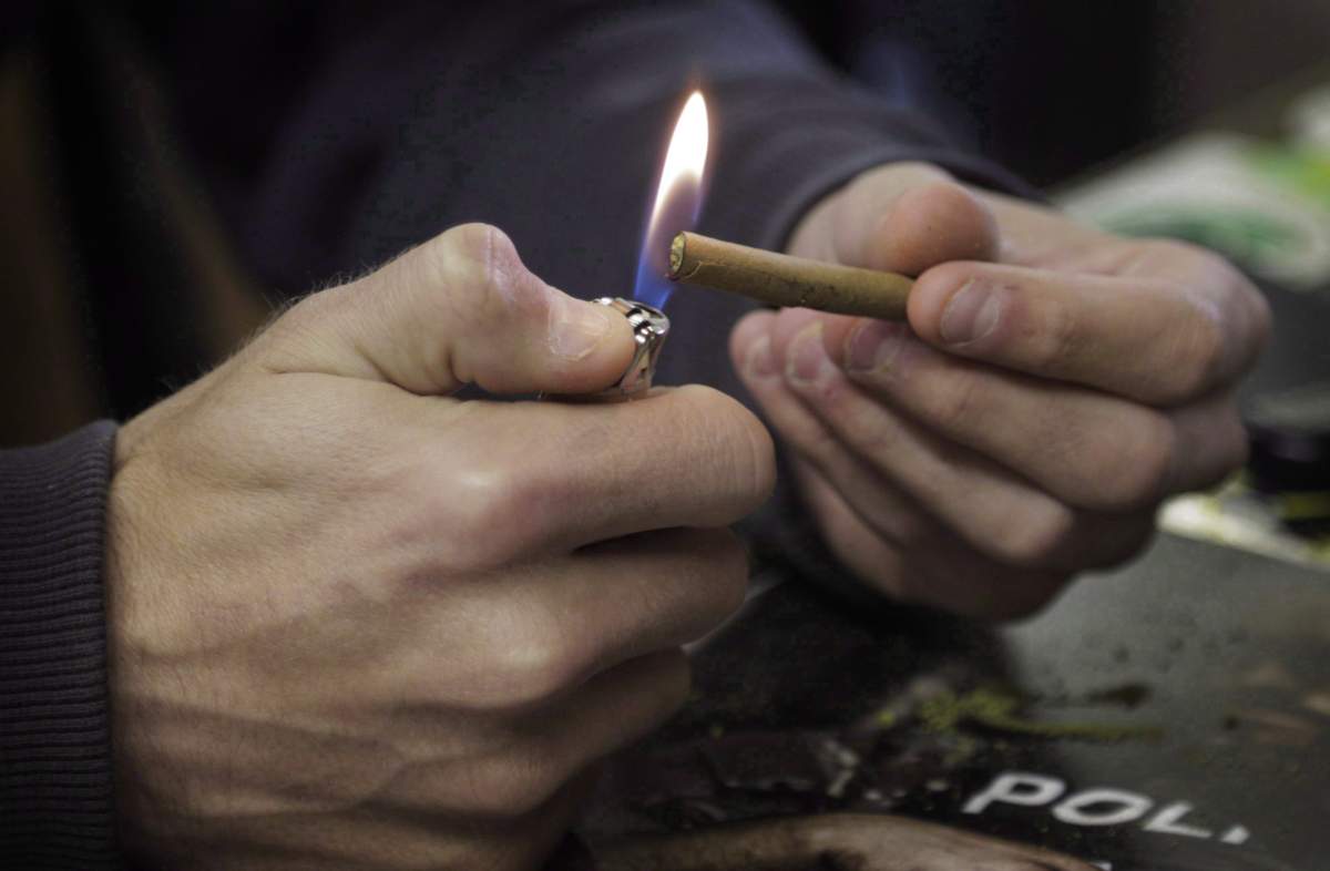 Daniel Jordan, 25, Tampa, Fla., lights a marijuana cigarette at the iBake smoking lounge in Denver on Tuesday, April 25, 2017. There are 385 dispensaries where cannabis connoisseurs can buy a dizzying array of dried bud, potent extracts and colourful edibles in Denver. THE CANADIAN PRESS/Joe Mahoney.