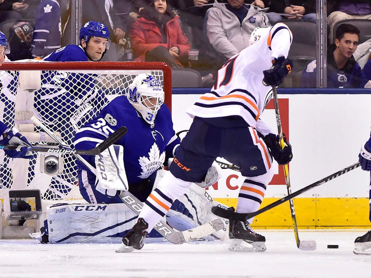 Toronto Maple Leafs goalie Curtis McElhinney (35) makes a save against Edmonton Oilers centre Connor McDavid (97) during second period NHL hockey action in Toronto on Sunday, December 10, 2017. THE CANADIAN PRESS/Frank Gunn