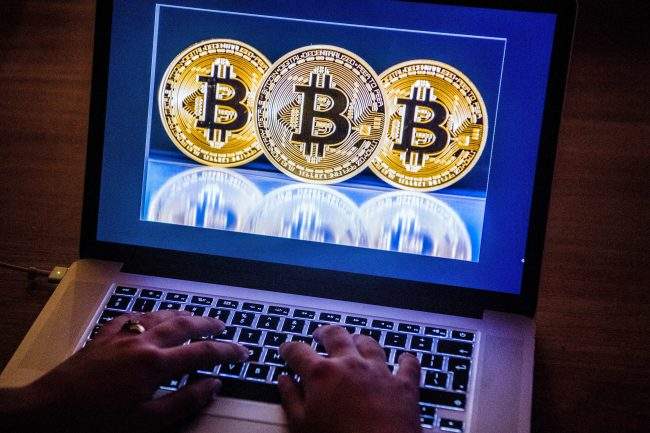 A view of Bitcoin coins on a computer screen on December 12, 2017. 


