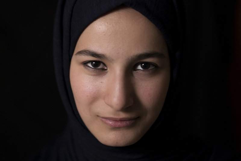 Ferah poses for a photo in her home in Mosul, Iraq, in this photo taken Saturday, Nov. 4, 2017. Ferah was just turning 14 and starting to look to the future when the Islamic State group took over Mosul in 2014, throwing her world into darkness. Afraid to leave the house, the teenager had to find some way to endure. 