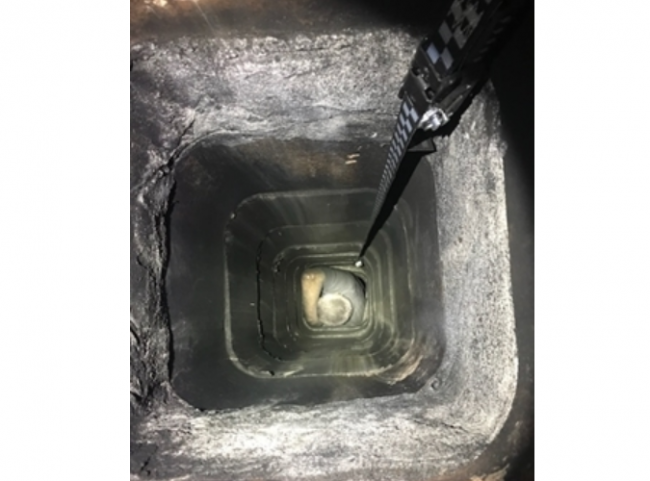 Police photo of suspect Jesse Beruba stuck in a chimney during a burglary attempt.