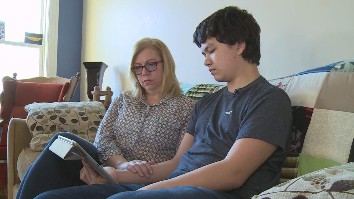Cuen Eng (right) sits at home with his mother Marni Adams.