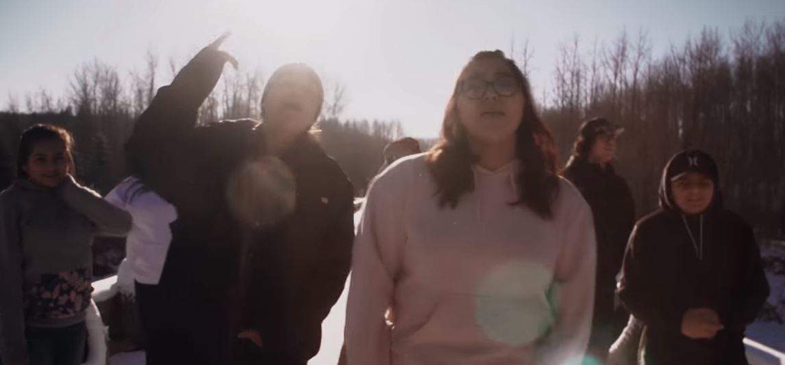 The seven First Nations youth featured in the video are: Trinity Desjarlais, Remington Davis, Tichia Davis, Douglas Jensen-Apsassin, Nikita Jensen-Apsassin, TJ Sochan, and Charlie Yahey.