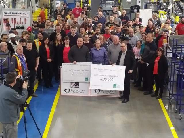 Campaign Chair Wayne Dunn accepts a pair of donations.
