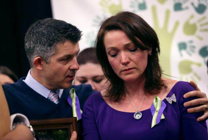 Ian Hockley and Nicole Hockley, parents of Sandy Hook massacre victim Dylan Hockley (6), embrace during a press conference with fellow parents of victims on the one month anniversary of the Newtown elementary school massacre on Jan. 14, 2013.