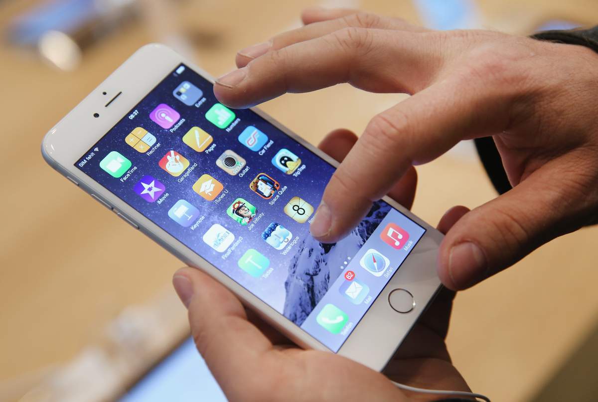 A shopper ltries out the new Apple iPhone 6 at the Apple Store on the first day of sales of the new phone in Germany on September 19, 2014 in Berlin, Germany.