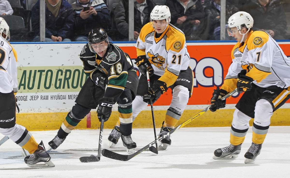 LONDON, ON - Liam Foudy #18 of the London Knights battles for a puck against Adam Ruzicka #21 of the Sarnia Sting during an OHL game at Budweiser Gardens in London, Ontario, Canada. (Photo by Claus Andersen/Getty Images).