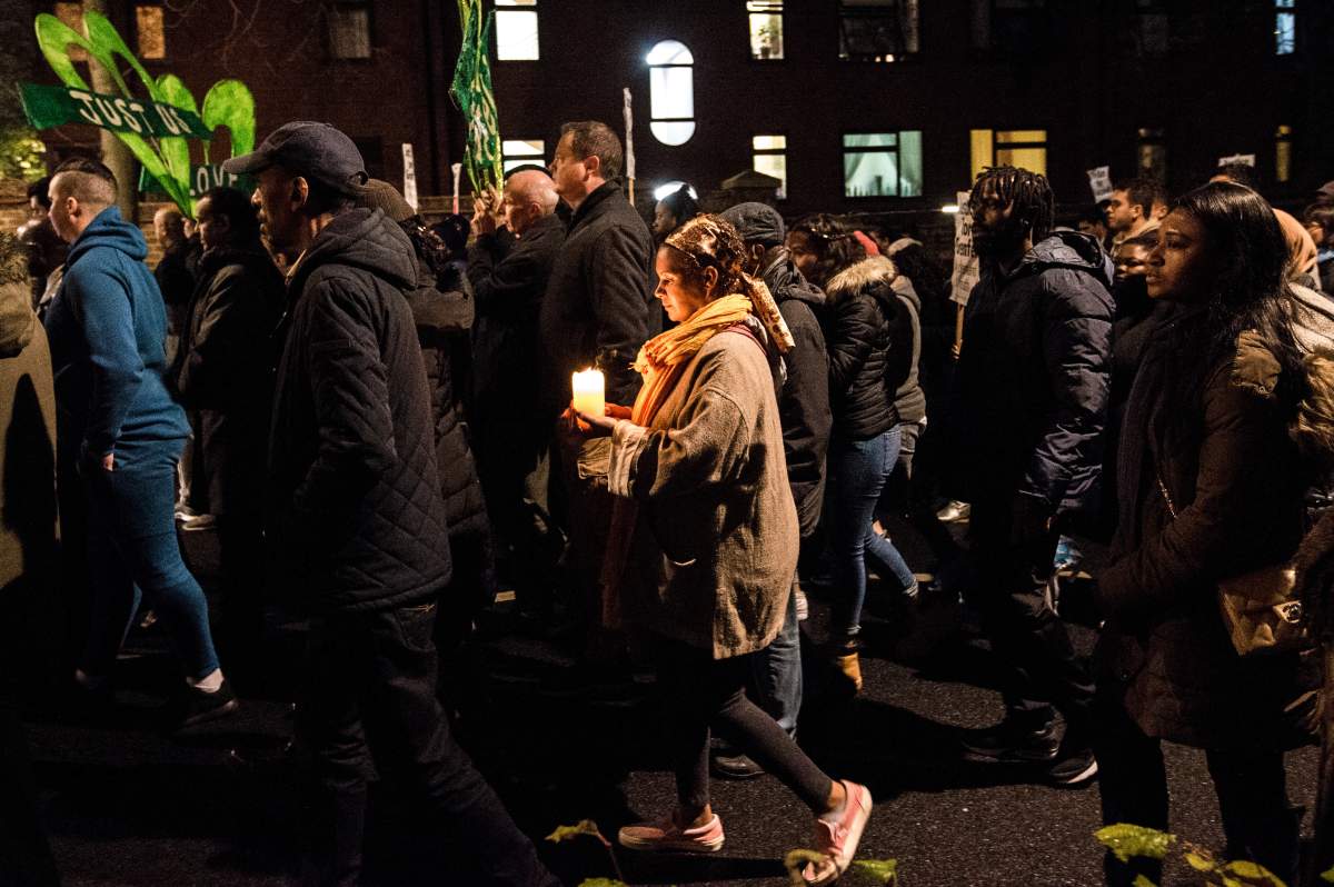 A woman seen holding a candle during the monthly silent march for the Grenfell Tower fire victims. (Photo by Brais G Rouco/SOPA Images/LightRocket via Getty Images)