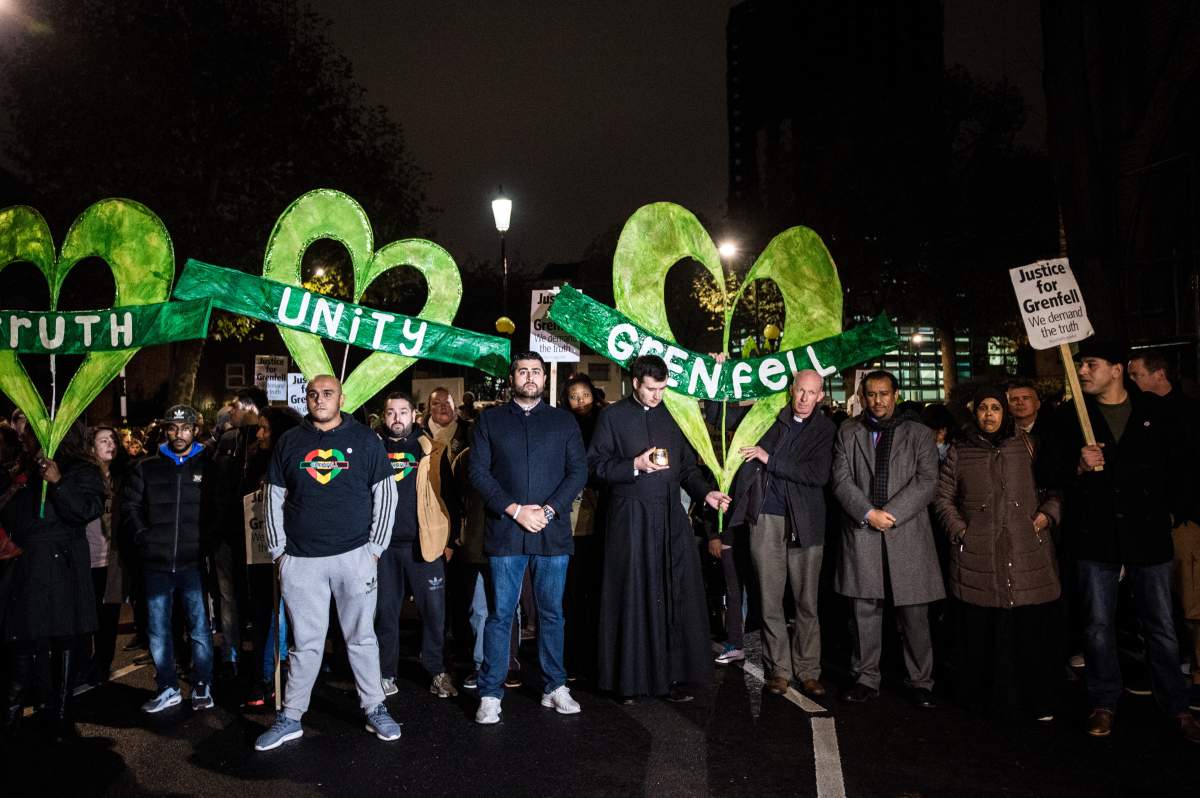 NOTHING HILL, LONDON, UNITED KINGDOM – 2017/11/14: Local people seen during the monthly silent march for the Grenfell Tower fire victims.Around 1,000 people joined the monthly silent march at night to commemorate the victims of the Grenfell Tower fire. The march marks five months since the June 14 fire, which spread ferociously through the 24-storey west London block and killed 80 people. (Photo by Brais G Rouco/SOPA Images/LightRocket via Getty Images)