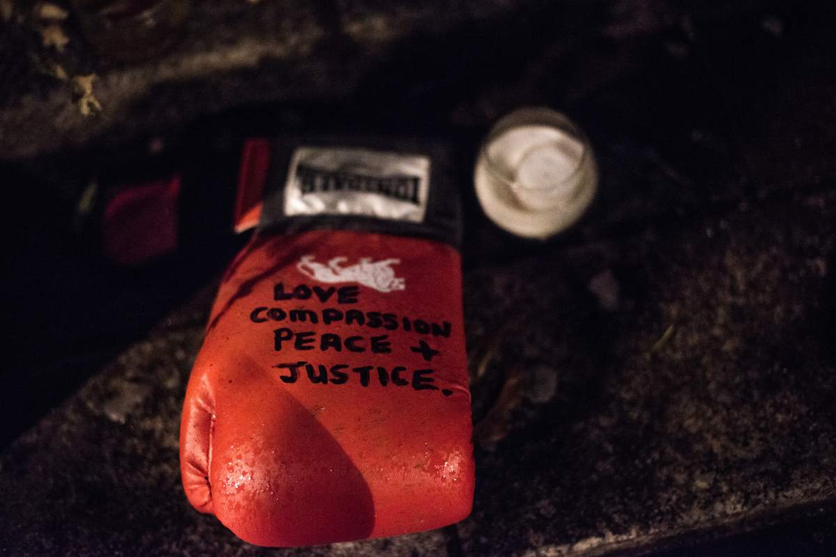 A boxing glove is placed in remembrance of the Grenfell fire disaster. Around 1,000 people joined the monthly silent march at night to commemorate the victims of the Grenfell Tower fire. (Photo by Brais G Rouco/SOPA Images/LightRocket via Getty Images)