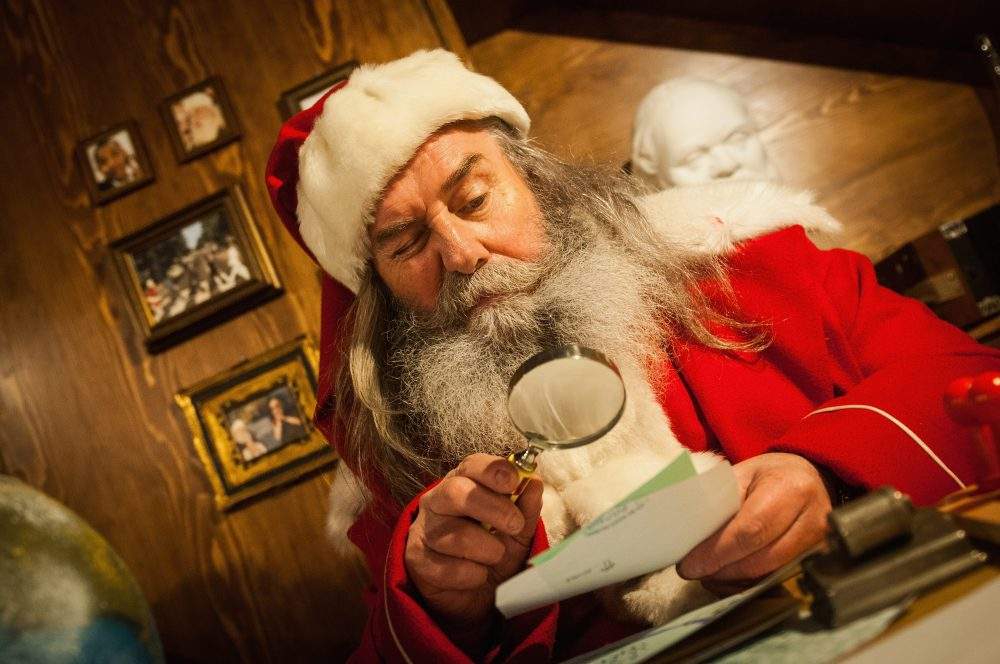 Santa Claus reads a letter in his house in the Reggia of Venaria on December 2, 2017 in Turin, Italy.