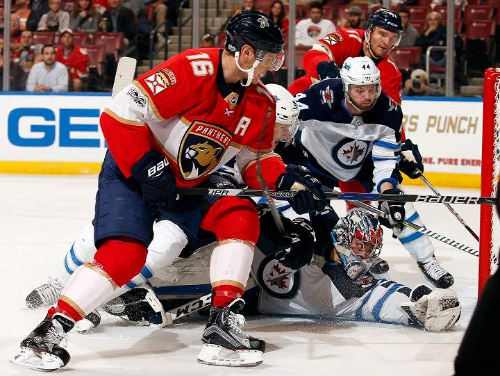 Goaltender Eric Comrie of the Winnipeg Jets defends the net against Aleksander Barkov of the Florida Panthers at the BB&T Center on Dec. 7 in Sunrise, Florida.