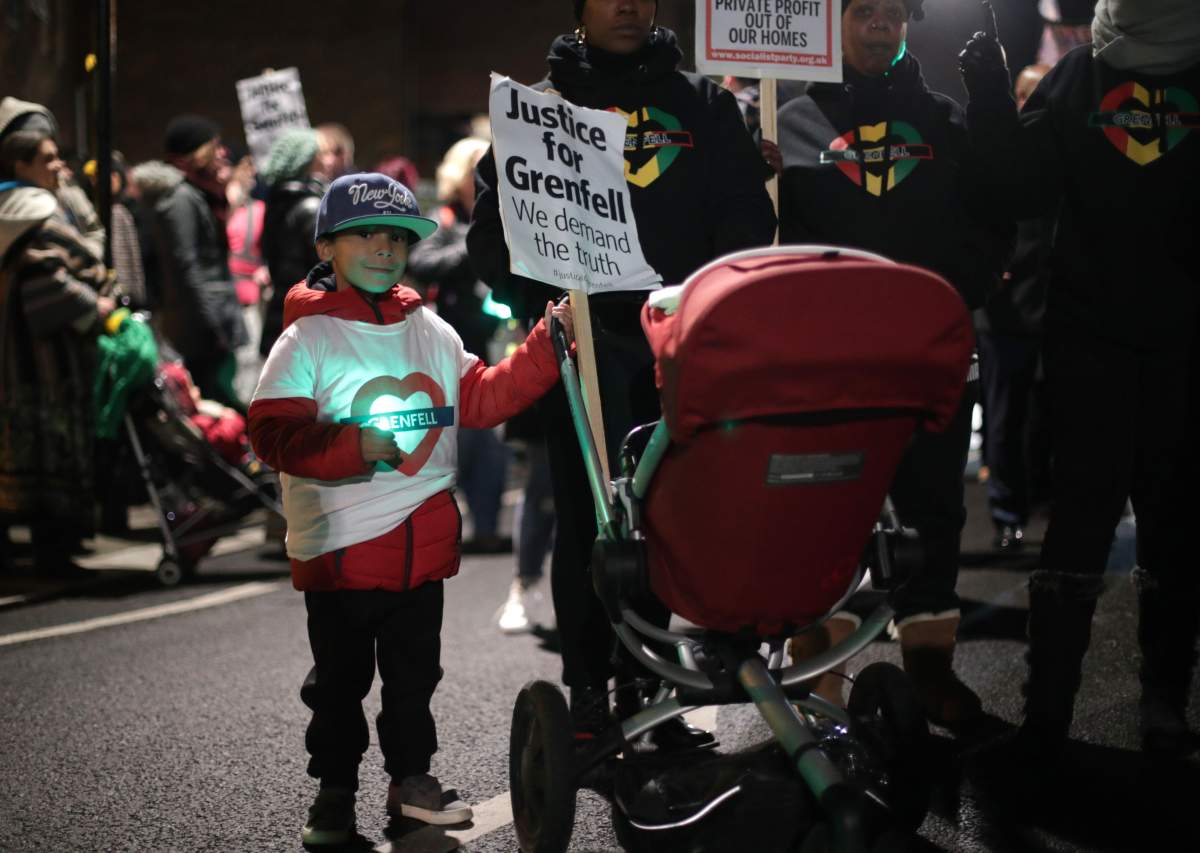 People take part in a silent walk to mark the six month anniversary of the Grenfell Tower fire, in west London. (Photo by Yui Mok/PA Images via Getty Images)