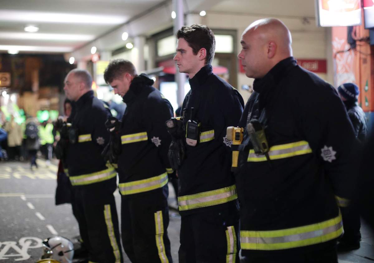 Firefighters pay their respects as people take part in a silent walk to mark the six month anniversary of the Grenfell Tower fire, in west London. (Photo by Yui Mok/PA Images via Getty Images)