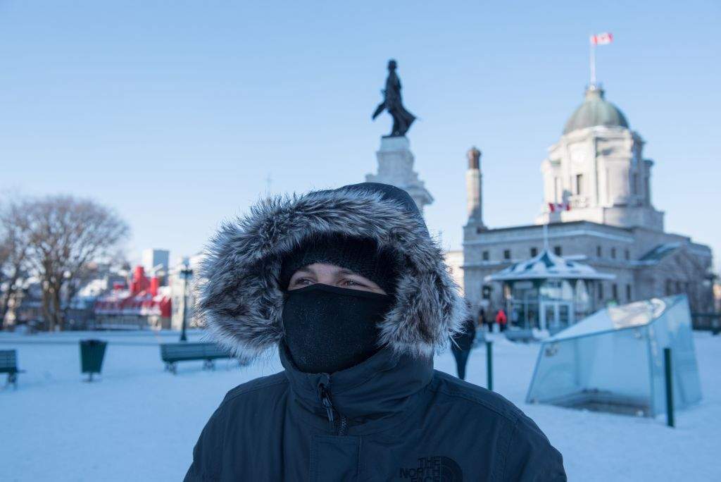 People walk through snow on a cold day in Quebec City on Dec. 27, 2017.In Canada, extreme cold warnings were issued for scores of communities across the country, including the heavily-populated provinces of Ontario and Quebec.
