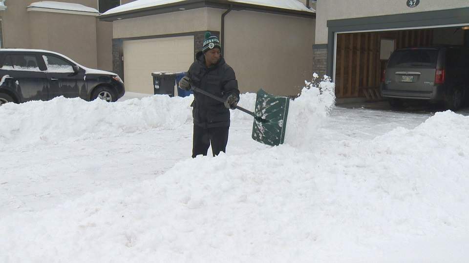 A Winnipegger shovels snow in this file photo.