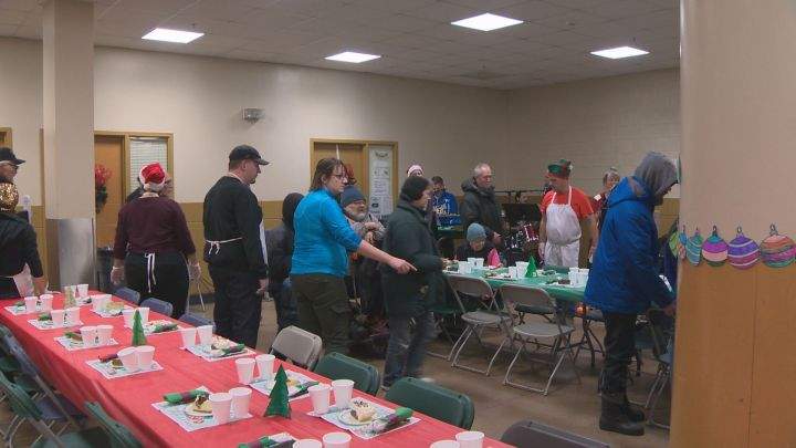 Staff and volunteers at Edmonton’s Hope Mission welcome hungry people arriving at their Christmas Banquet on Dec. 4, 2017.