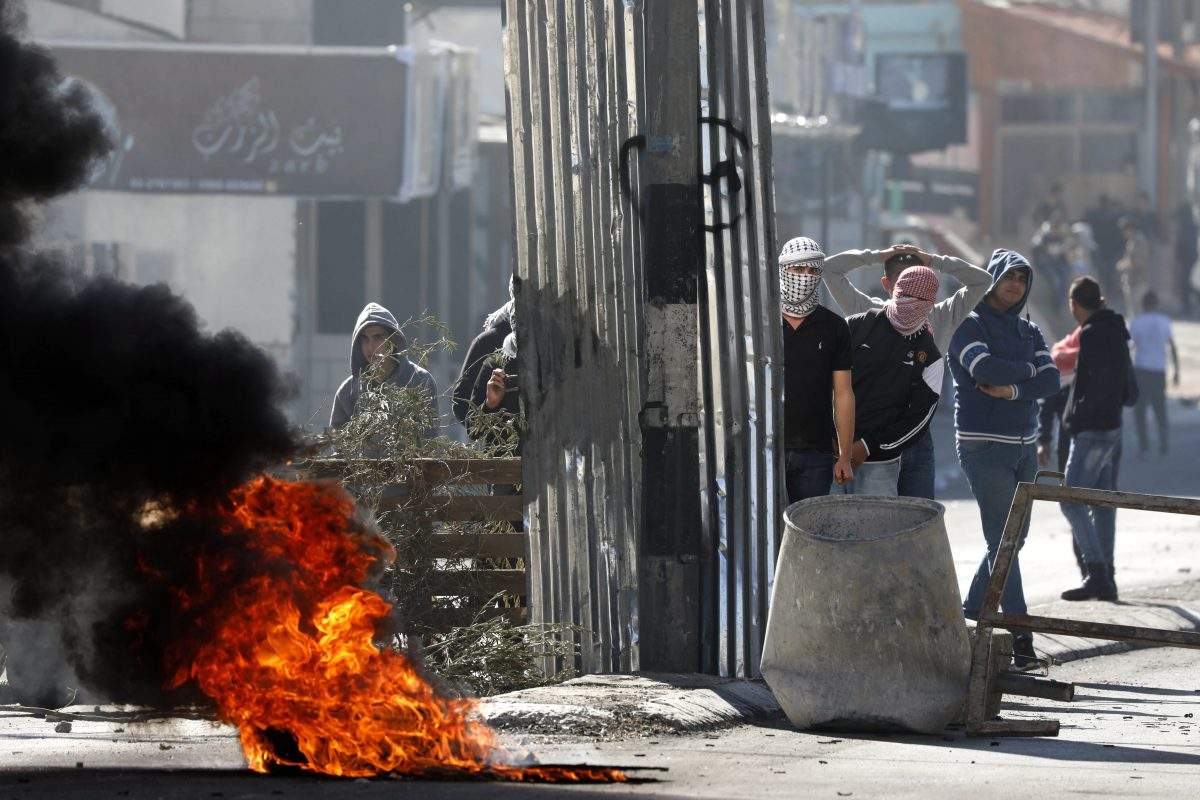 Palestinians throw stones at Israeli troops during clashes in the West Bank City of Bethlehem, 09 December 2017.