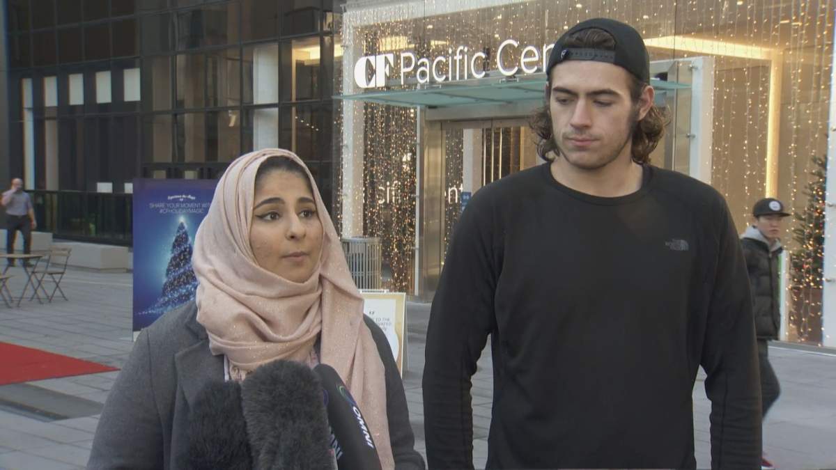 Noor Fadel, left, standing with Jake Taylor, the young man who stood between her and a man who allegedly said he’d “kill all Muslims” on the Canada Line Monday night.