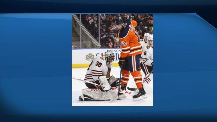 Chicago Blackhawks goalie Jeff Glass (30) makes the save on Edmonton Oilers' Patrick Maroon (19) during second period NHL action in Edmonton on Friday December 29, 2017. 