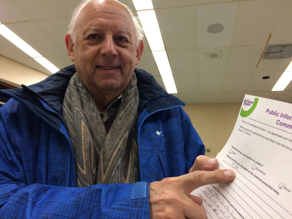 A Londoner shows off a BRT comment page at a public information centre meeting.