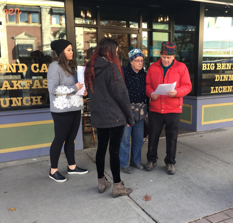 Family members of missing Alberta pilot Dominic Neron hand out missing persons flyers in Revelstoke. 