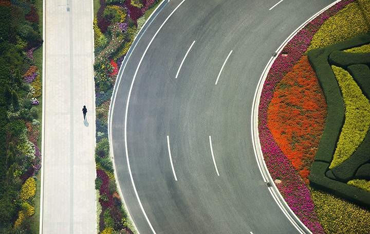 A person walks along a footpath outside the Fortune Global Forum in Guangzhou, China, on Dec. 6, 2017.