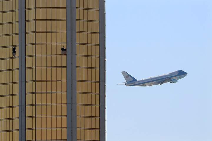 Air Force One departs Las Vegas past the broken windows on the Mandalay Bay hotel, where shooter Stephen Paddock conducted his mass shooting along the Las Vegas Strip in Nevada, October 4, 2017.