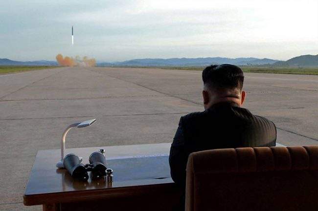North Korean leader Kim Jong Un watches the launch of a Hwasong-12 missile in this undated photo released on Sept. 16, 2017.