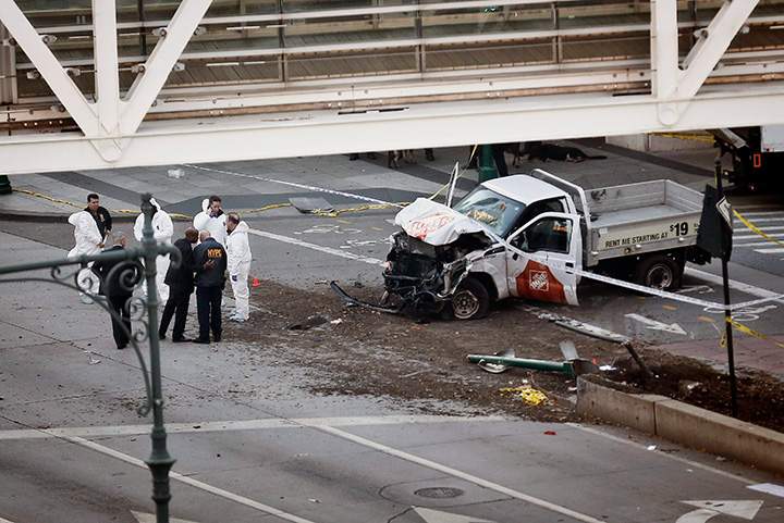 Authorities stand near a damaged Home Depot pickup truck after its driver drove onto a bike path near the World Trade Center memorial in New York, striking and killing several people on Oct. 31, 2017.