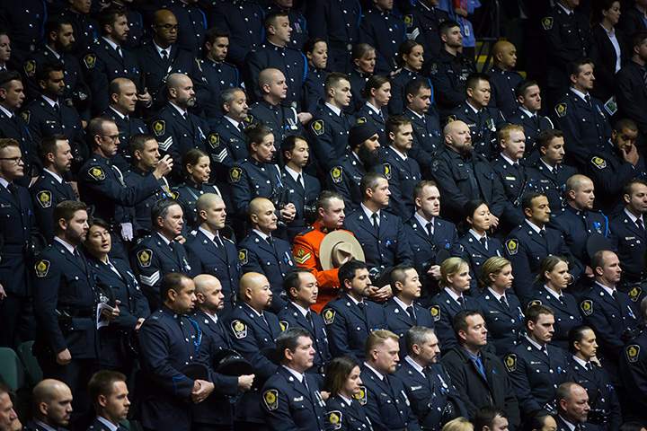 A Royal Canadian Mounted Police officer stands among Vancouver Police officers during a memorial for Abbotsford Police Const. John Davidson, who was killed in the line of duty on November 6.