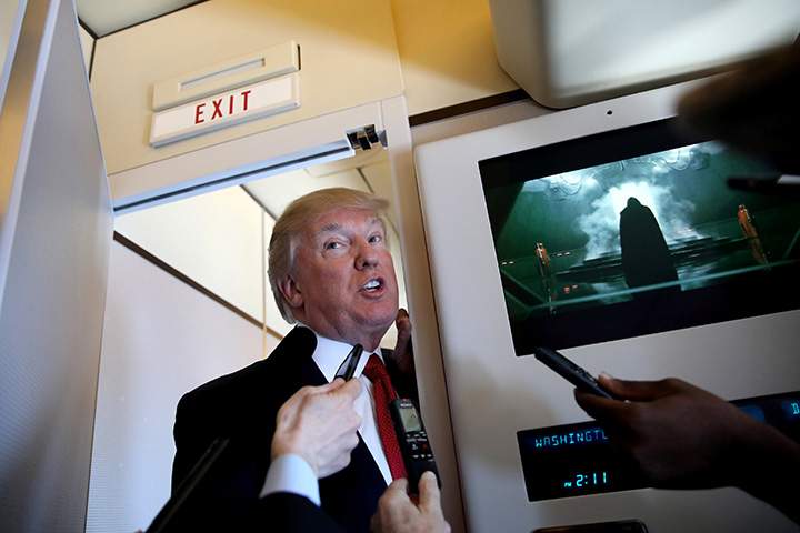 U.S. President Donald Trump talks to journalists on board Air Force One during his trip to Palm Beach, Florida, April 6, 2017.