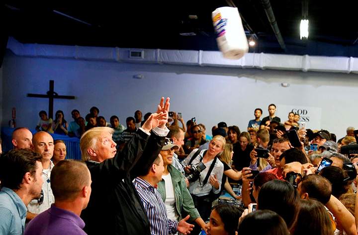 U.S. President Donald Trump throws rolls of paper towel into a crowd of local residents affected by Hurricane Maria as he visits San Juan, Puerto Rico, October 3, 2017.