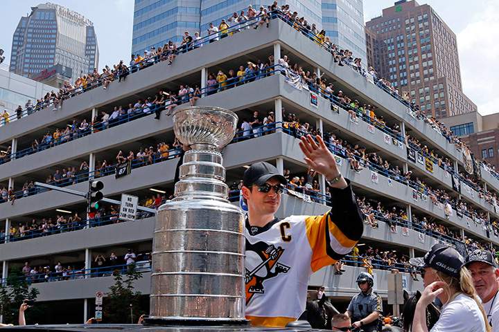 Pittsburgh Penguins’ Sidney Crosby rides with the Stanley Cup during a victory parade in Pittsburgh on June 14, 2017.