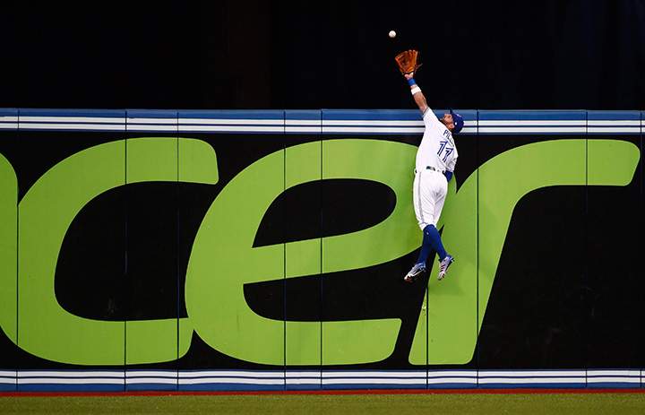 Toronto Blue Jays centre fielder Kevin Pillar climbs the wall but can’t make the catch on a solo home run by New York Yankees catcher Gary Sanchez on Wednesday, August 9, 2017.