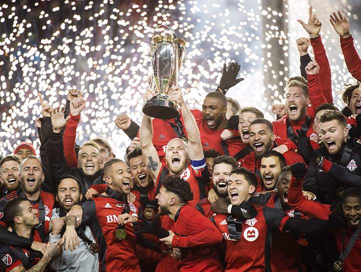 Toronto FC midfielder Michael Bradley hoists the MLS Cup with teammates after defeating the Seattle Sounders in Toronto on Saturday, December 9, 2017.