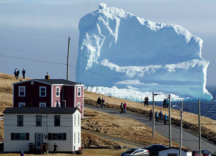 Residents view the first iceberg of the season as it passes the South Shore, also known as “Iceberg Alley”, near Ferryland Newfoundland, April 16, 2017.