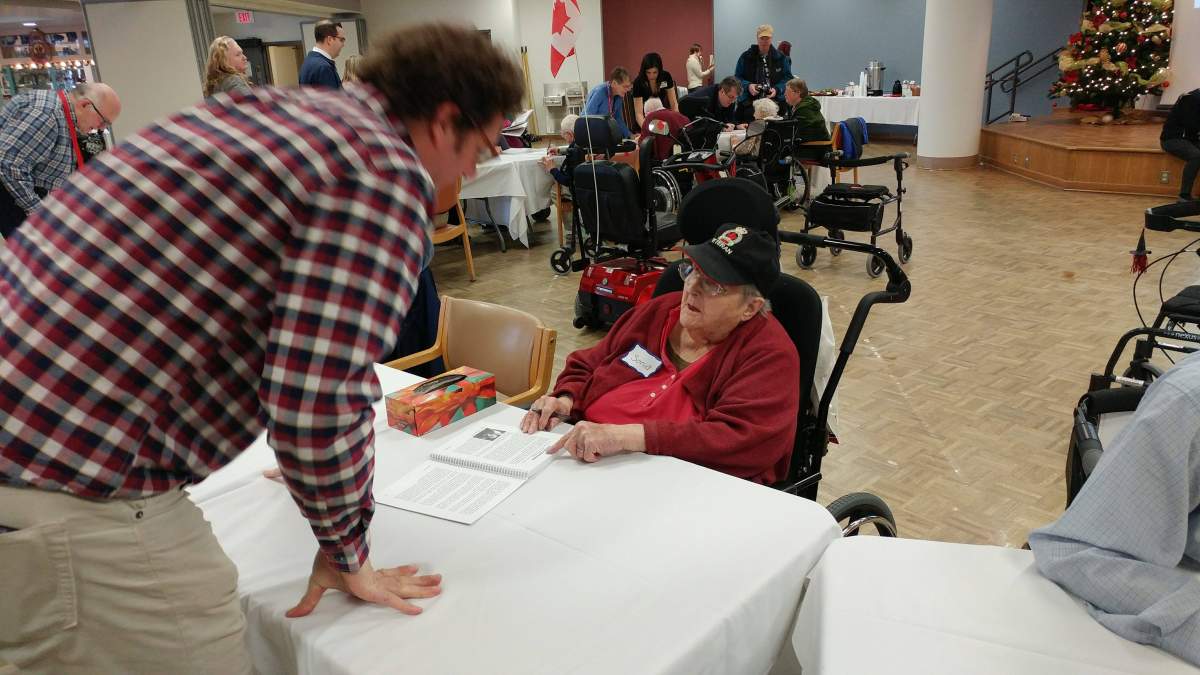 Sonia Kaipainen signs a book for an eager fan at Wednesday book signing at Parkwood Institute.