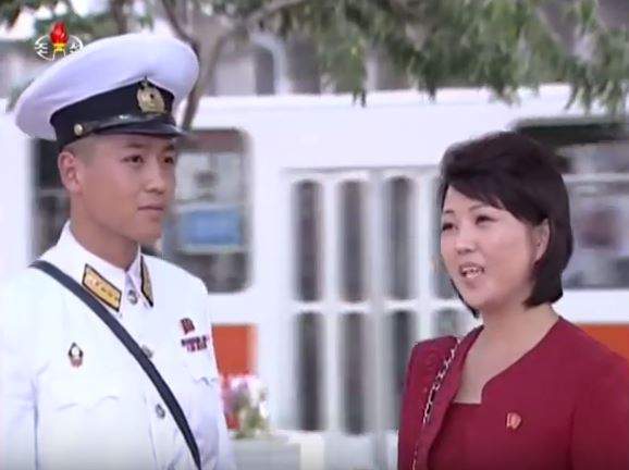 The clean-cut sailor hero of the North Korean drama “Value Others” gets help from a well-dressed lady on the streets of Pyongyang.